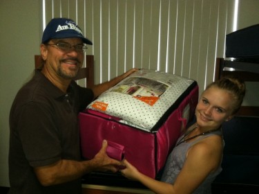 Thomas Popik of Phoenix helps his daughter, Alicia, load into her room.