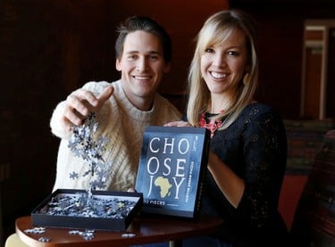 Caleb and Sarah Thatcher used an African jigsaw puzzle to help raise money for the adoption of two Ugandan children. (Photo by Darryl Webb)