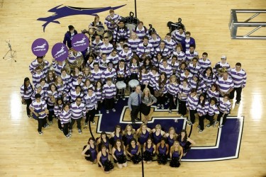 Paul and G.K. Koch pose with members of the GCU dance team and Thundering Heard Pep Band at GCU Arena. The Kochs collaborated to create a high-energy trash-can halftime performance. (Photo by Darryl Webb)