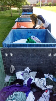 GCU student Danielle Davich sorts through donation bins near Prescott Hall. 