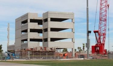 The new parking garage on 35th Avenue has gone vertical. By August, the campus will have an additional 1,380 parking spaces. 