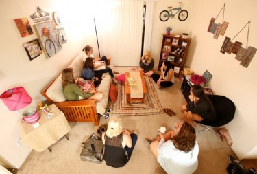 GCU senior Courtney Roth (seated in the middle on the couch) meets every week in her campus apartment with other female students.
