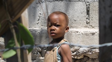 A boy in Titanyen, Haiti, filled his belly with nutritious meals of rice, soy and vitamins, thanks to the global nonprofit, Feed My Starving Children. It is being supported by GCU during a volunteer event on Saturday on campus. Photo courtesy of Josh Thrall