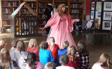 Fairy Godmother, played by GCU theatre student Kayana Sweeney, has the attention of children at Atonement Lutheran School on Tuesday during a performance of a twist on "Hansel and Gretel."