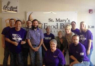 Steele (second from left) and other online faculty members volunteer at St. Mary's Food Bank in Phoenix. He is heavily involved in on-campus activities, and he shares those experiences with his students to help familiarize them with campus. (Photo courtesy of John Steele)