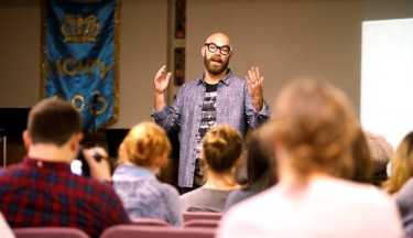 Christian songwriter Tim Timmons addresses students in his visit to the Monday evening class.
