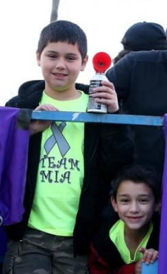 Jimmy (left) and Jacob Bryant blew the air horn on behalf of their race starter sister, Mia, who was too ill to attend the run. (Photo by Darryl Webb) 