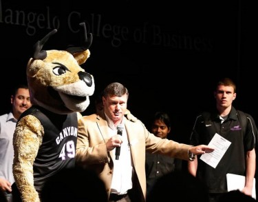 Master of ceremonies Tim Kelley, an assistant professor in the Colangelo College of Business, is joined by Thunder and student Geoff Breed, winner of a $1,000 prize at Tuesday's Canyon Challenge. 