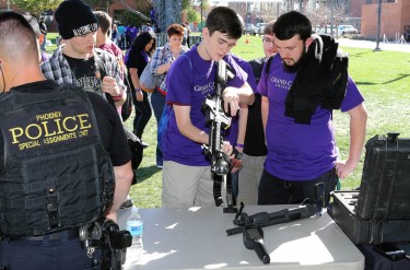 Students learn about law enforcement tools at a booth hosted by the Phoenix Police Department's Special Assignments Unit (aka, the SWAT team). 