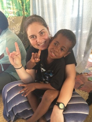 Anamaria Lup does Lopes Up with a boy in Fiji during a GCU mission trip. (Photo courtesy of Anamaria Lup)