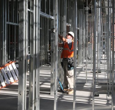 A construction worker eyes the beams in the engineering building.