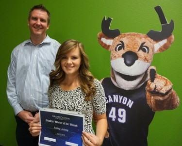 Bailey Lindsey (center) celebrates being named the April GCU Student Worker of the Month with her manager, Ricky Bezanson, and Thunder. 