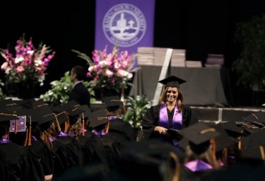 Kristie Lara walks down the aisle with the last diploma that was handed out Saturday afternoon. (Photo by Darryl Webb)