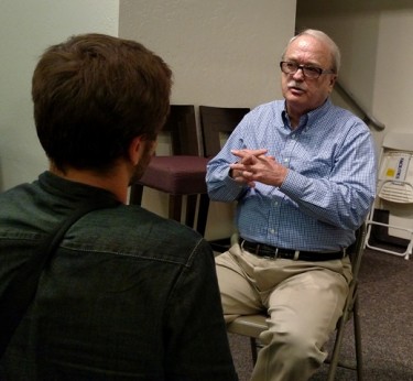 Dr. J.P. Moreland speaks with a student after his talk Wednesday night.