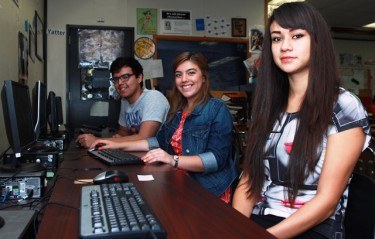 Independence High newspaper editors (from left) Justin Leano, Julianna Cortez and Bianca Ramirez work on their final journalism projects in class. 