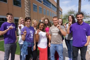Recent GCU graduates (from left) Andrew Kretzmann, Ellie Evans, Allison Bauer, Hillary Olsker, Shauna Edwards, Kelsi Thomas, James Prigge, Jessica Ament, Brittney Spackman and Tyler Troth put their Lopes Up at the Peoria site, where their roles range from enrollment counselors to IT desktop support.