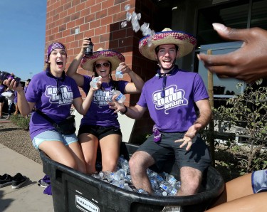 Student volunteers found a good use for the bins full of ice and cold drinks. (Photo by Darryl Webb)