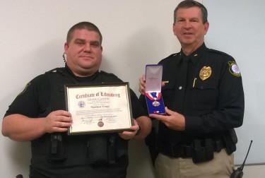 Lupe awarded Medal of Life Saving and certificate for saving a man's life.
