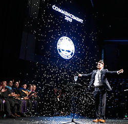 Commencement speaker Jared Hall makes it "snow" in Phoenix at the conclusion of his address. (Photo by Darryl Webb)