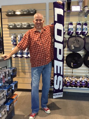 ope Shop manager Andy Dunn shows the Lopes scarves available for $32.99.