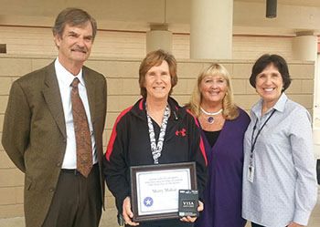 Mary Makar (second from left), principal of Osborn Middle School, accepts an award for her work in supporting STEM education at her school from Jon Benton, an architect at Orcutt/Winslow, Dr. Beverly Hurley, director of academic alliances in GCU's Strategic Educational Alliances, and Patty Tate, superintendent of the Osborn Elementary School District. 