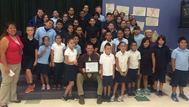 Flanked by his students at Sun Canyon Elementary in XX is Principal Jonathan Rohloff, who received the principal of the month award from GCU's SEA. 