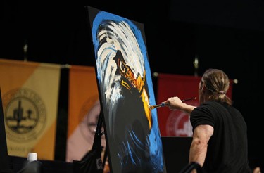 Erik Wahl quickly created two intriguing paintings during his commencement address Friday in GCU Arena. (Photo by Darryl Webb) 