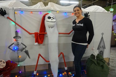 Kristina Morrow poses next to "Jack" from "Nightmare before Christmas"-theme of the Office of Financial Aid quality assurance team.