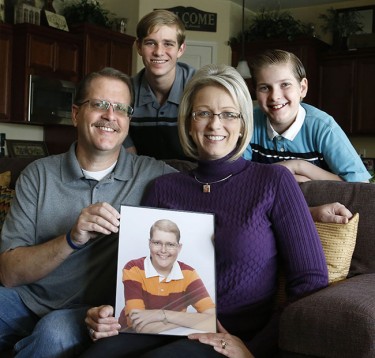 Grant and Carol Gary, a GCU alumna, and their sons, Jonathan (left) and Simon, pose with a photo of Evan Gary, their eldest boy, who passed away from leukemia. The Garys will participate in their third GCU Foundation Run to Fight Children’s Cancer on March 12 and recently initiated the Evan C. Gary Memorial Scholarship.