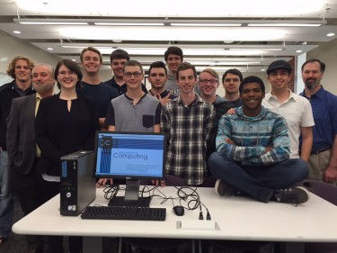 Members of GCU's Innovative Computing Club and their advisers display one of 100 computers they retrofitted and are deploying to charities.