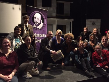 Dr. Paul Hartle from England, holding a book, was surrounded by students after lecturing during GCU's Shakespeare Week.