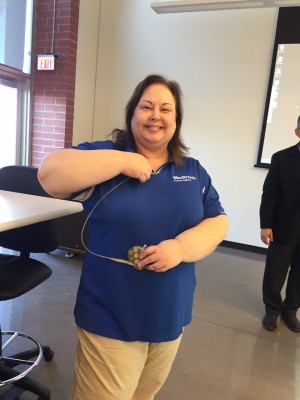 Pam Goux, with Medtronics, demonstrates an early generation pacemaker. 