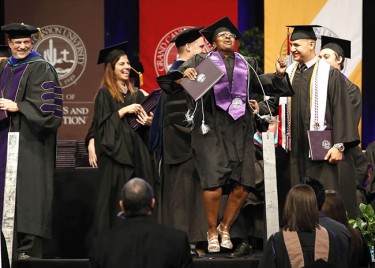 One graduate was so delighted, she broke into an impromptu dance onstage -- and kept going awhile. (Photo by Darryl Webb)