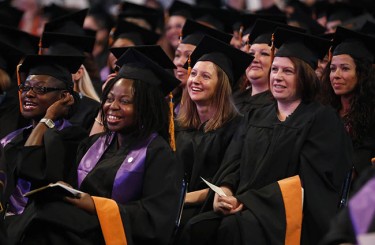 Graduates react to Justin Willman's act. (Photo by Darryl Webb)