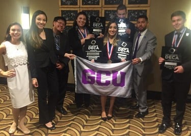 GCU students display their plaques after they had several outstanding finishes in the DECA International Career Development Conference in Washington, D.C.