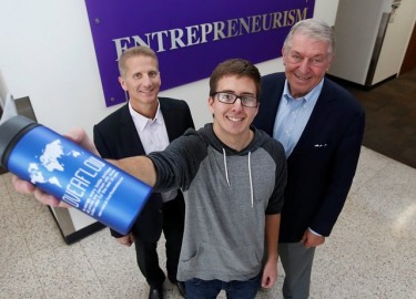 David LaJeunesse, joined by Dr. Randy Gibb, the CCOB dean (left), and Jerry Colangelo, for whom the college is named, displays one of his Overflow Bottles.