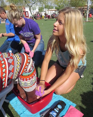 Sophomore Megan Floyd washes a woman’s feet.