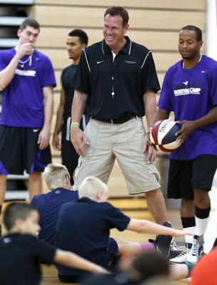 Head coach Dan Majerle interacts with the camp participants during stretching.