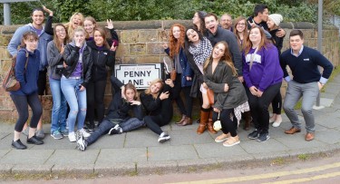 Students stopped at Penny Lane in Liverpool, England, the home of "The Beatles."