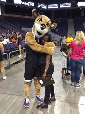 Thunder came to cheer during the clothing drive, and gave a hug to Carla Gentles, the executive director's wife.