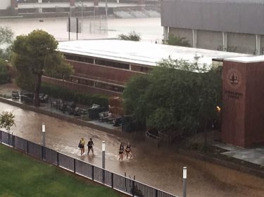 Students wade through the water that engulfed parts of the campus during the storm.