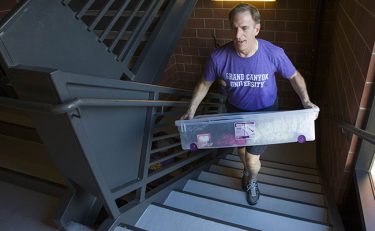Senior writer Rick Vacek takes one of his 10 trips up the stairs as a Move-In volunteer.