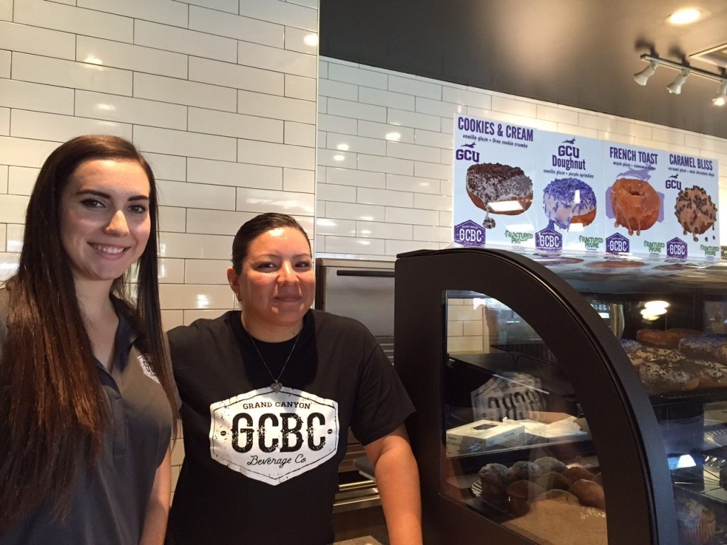 Two of GCBC's shop managers, Lauren Lentini, left, and Julisa Smith, stand by the doughnut case at the brand new coffee shop. 