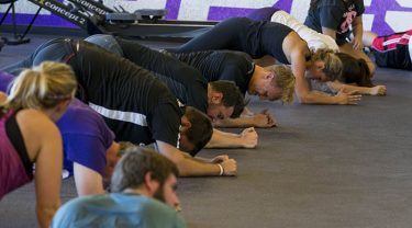 Staff and students do the "plank" exercise at boot camp. (Photo by Darryl Webb)