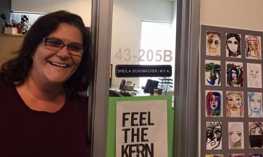 Schumacher in her office doorway. Kern is the space between the letters, she said of the "Feel the Kern'' poster.