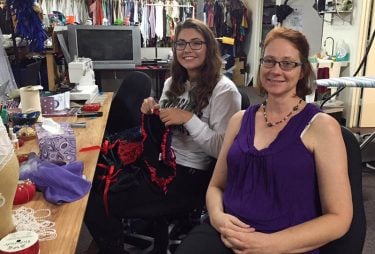 Student Kara Newman, left, and Costume Designer Nola Yergin consult over a costume in progress.