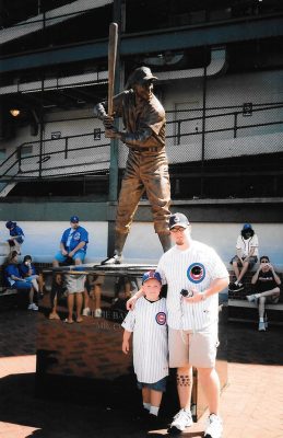 Bart Barrett with his son Alex in front of the statue of Ernie Banks at Wrigley Field.