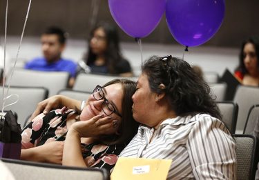 Brenda Batres (left) rested her head contentedly on the shoulder of her mother, Sandra, after learning that she had won a scholarship.