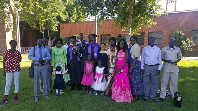 Bol Bior Kur (tallest graduate in middle) poses with his family after commencement.