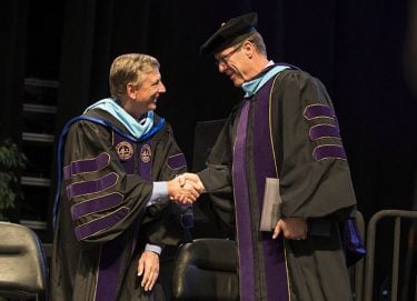 Griffin is congratulated by GCU President Brian Mueller (left).